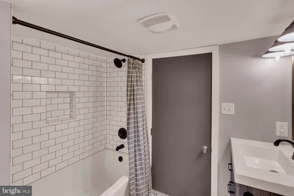 a bathroom with a bathtub and shower