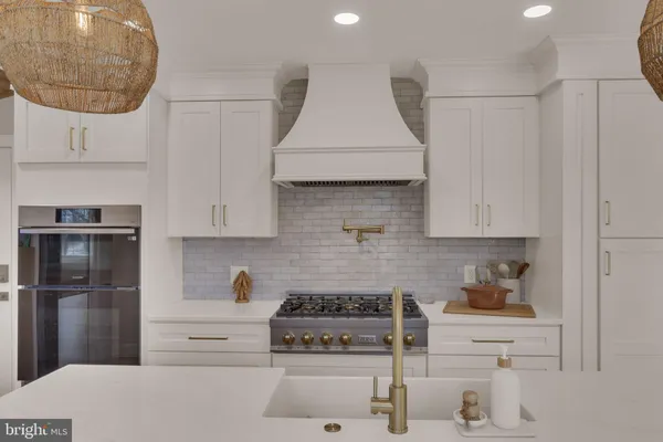 a kitchen with stainless steel appliances granite countertop a stove a refrigerator and a microwave