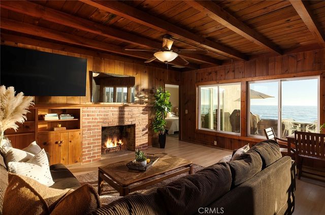 a living room with furniture fireplace and flat screen tv