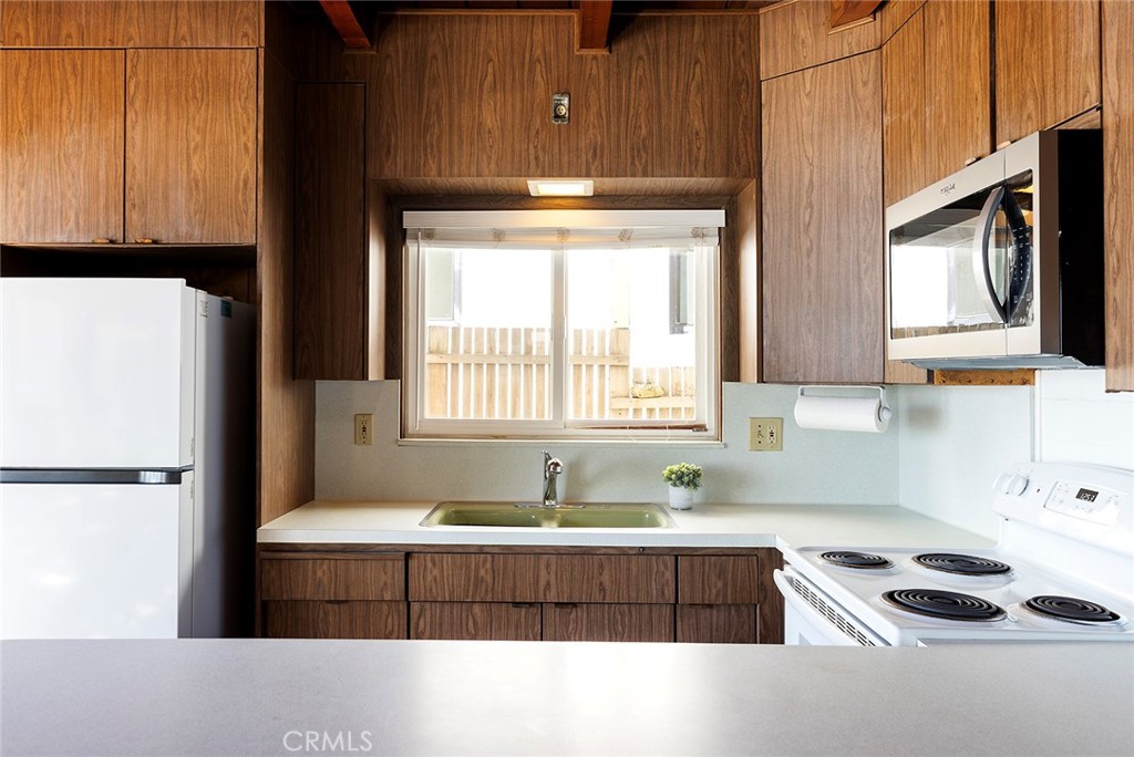 35711 Beach Road Dana Point, CA 92624 - Photo 13 of 47 a kitchen with stainless steel appliances a sink a stove a microwave a refrigerator and cabinets