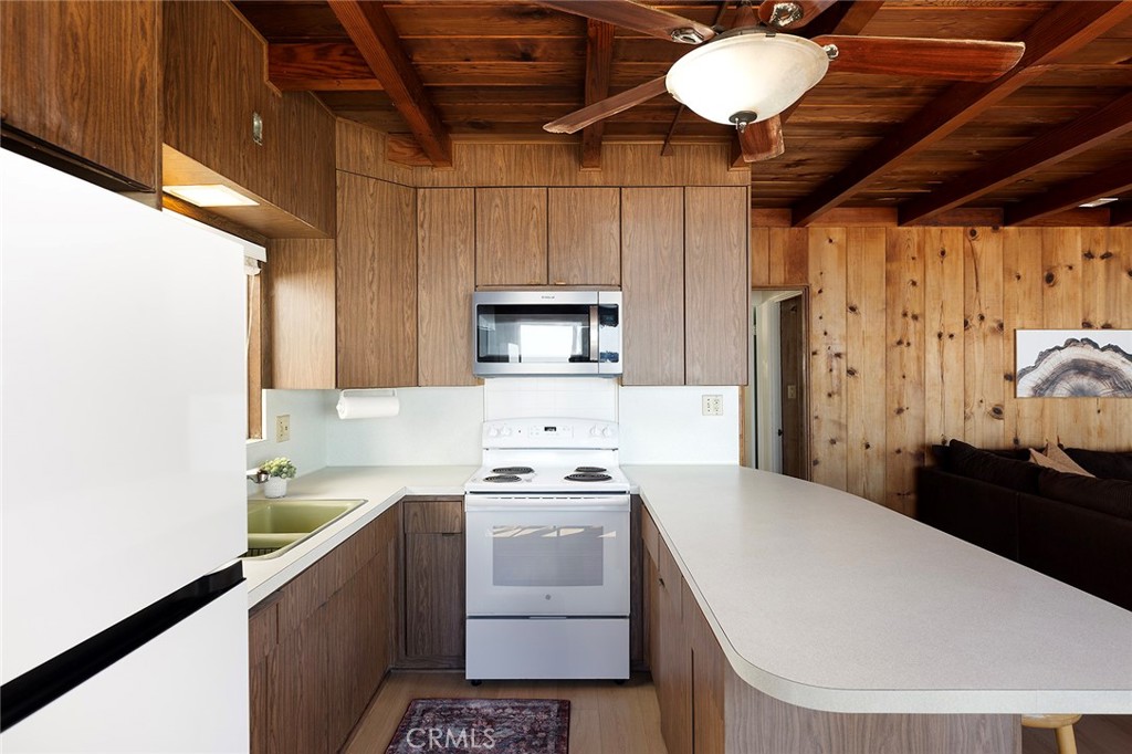 35711 Beach Road Dana Point, CA 92624 - Photo 13 of 47 a kitchen that has a sink a stove and a microwave oven in a cabinets