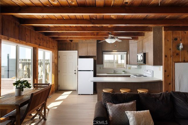 a dining room with furniture and a large window