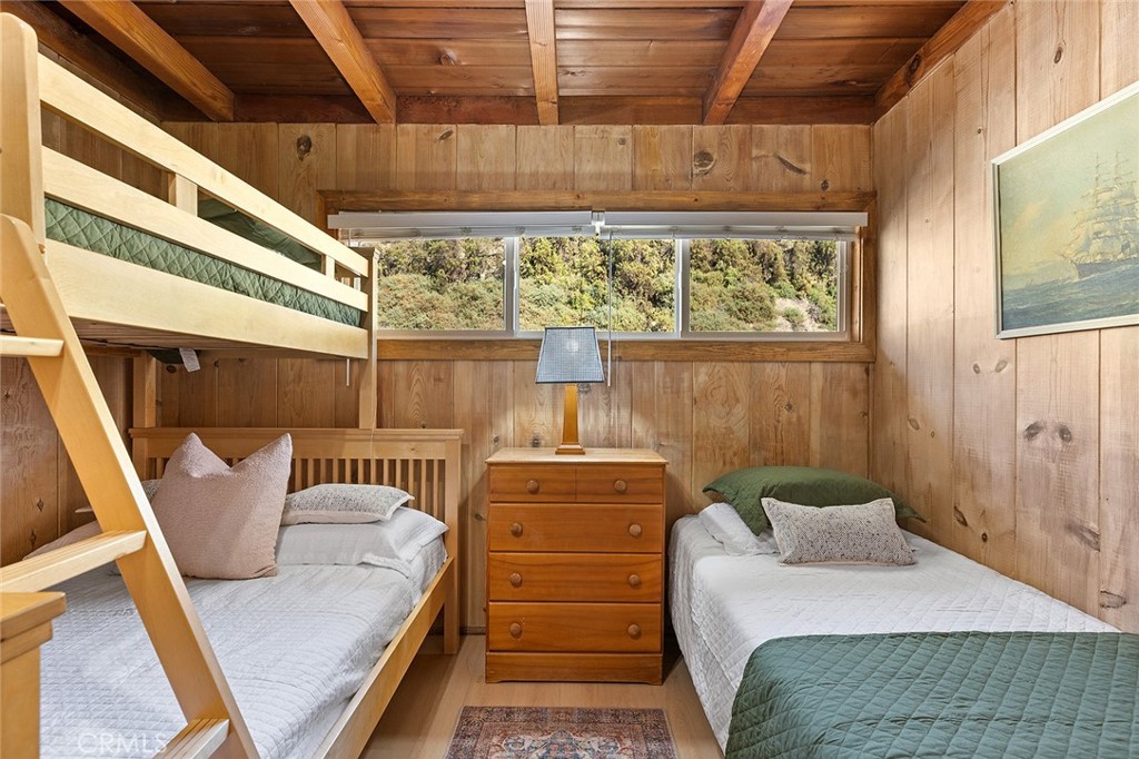 35711 Beach Road Dana Point, CA 92624 - Photo 33 of 47 a bedroom with a bed and wooden floor