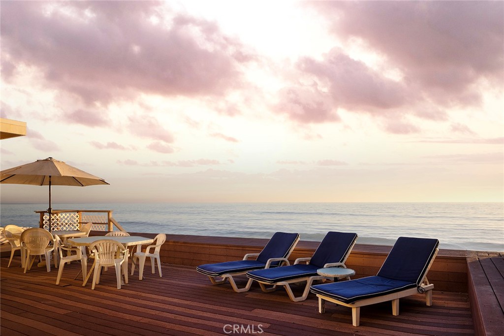 35711 Beach Road Dana Point, CA 92624 - Photo 4 of 47 an outdoor sitting area with furniture and umbrella