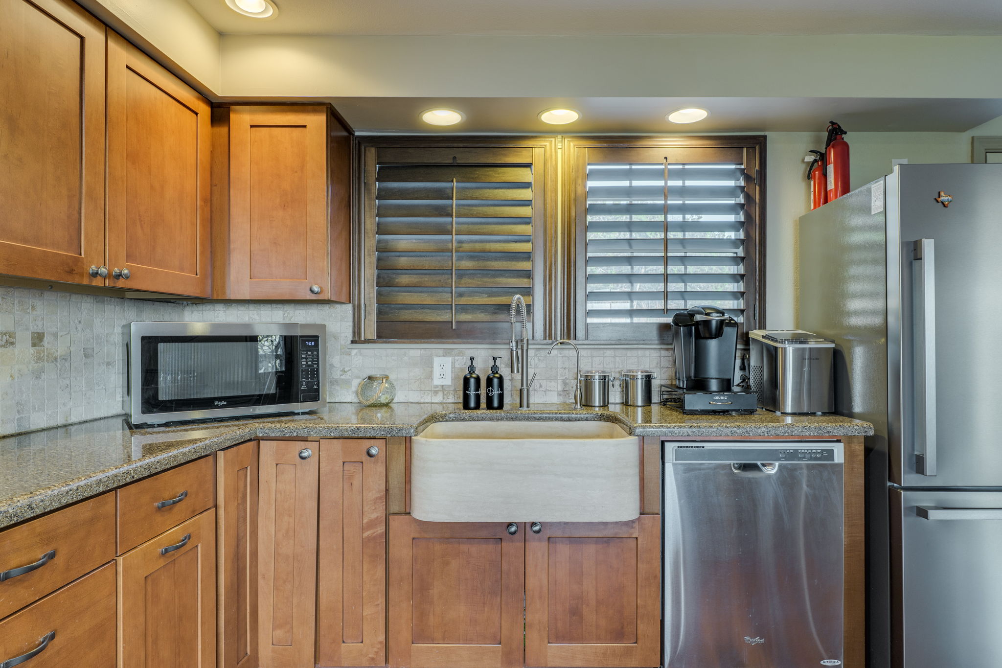 281 Kloster Lane Blanco, TX 78606 - Photo 15 of 40 a kitchen with stainless steel appliances granite countertop a stove a sink a refrigerator and a microwave
