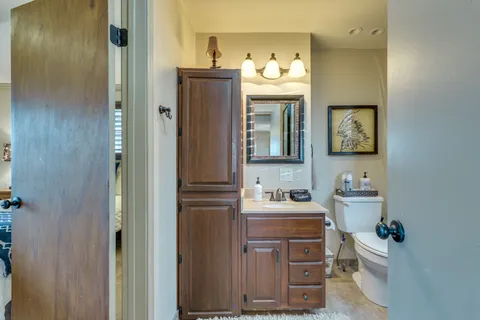 a bathroom with a toilet sink and shower