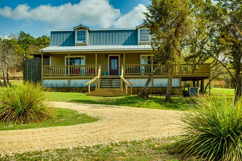 a balcony with potted plants and wooden floor