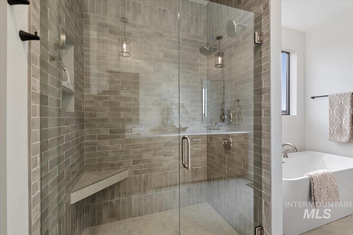 7624 West Old School Street, Unit FREMONT Meridian, ID 83646 - Photo 21 of 35 Full bathroom featuring a soaking tub and a stall shower