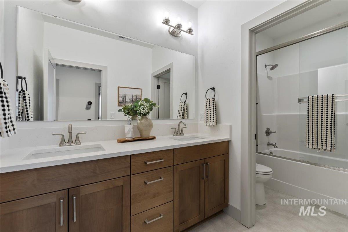 7624 West Old School Street, Unit FREMONT Meridian, ID 83646 - Photo 23 of 35 Full bath featuring shower / bath combination with glass door and double vanity