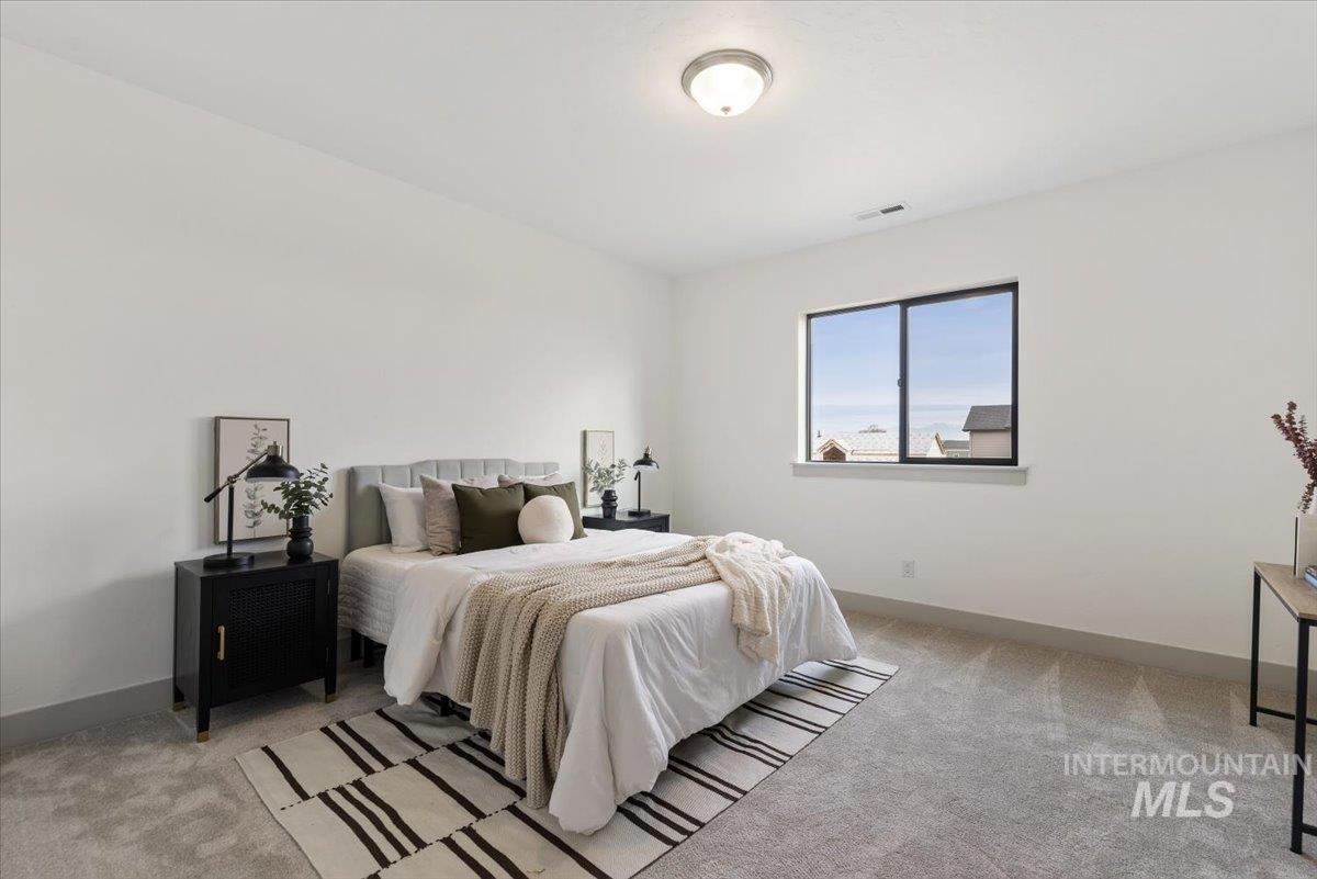 7624 West Old School Street, Unit FREMONT Meridian, ID 83646 - Photo 30 of 35 Bedroom with light colored carpet and baseboards