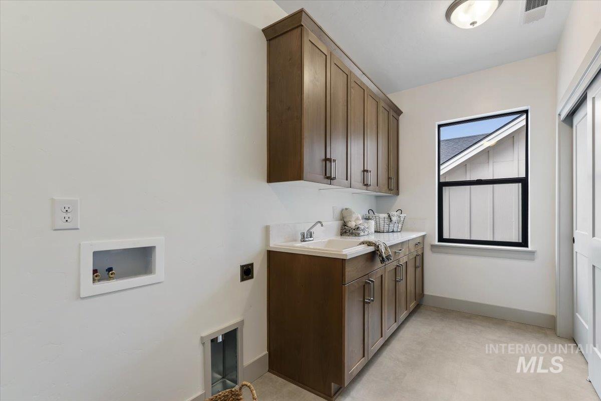 7624 West Old School Street, Unit FREMONT Meridian, ID 83646 - Photo 31 of 35 Laundry room featuring cabinet space, washer hookup, and hookup for an electric dryer