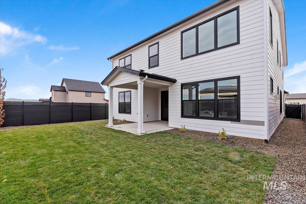7624 West Old School Street, Unit FREMONT Meridian, ID 83646 - Photo 32 of 35 Back of house featuring a patio area and a fenced backyard
