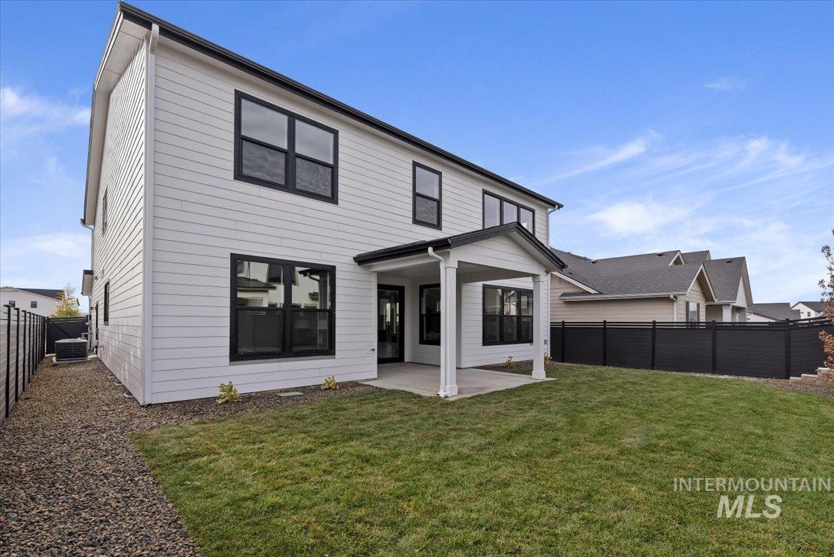 7624 West Old School Street, Unit FREMONT Meridian, ID 83646 - Photo 33 of 35 Rear view of property featuring a patio area and a fenced backyard
