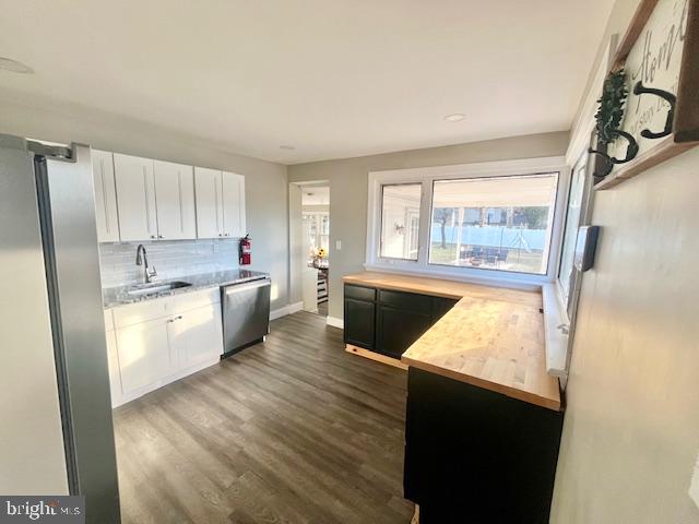 107 Robin Lane Voorhees, NJ 08043 - Photo 6 of 27 a kitchen with stainless steel appliances kitchen island wooden cabinets a stove a sink and a refrigerator