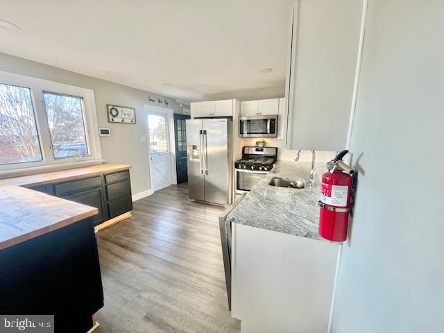 107 Robin Lane Voorhees, NJ 08043 - Photo 9 of 27 a living room with stainless steel appliances kitchen island granite countertop furniture and a fireplace