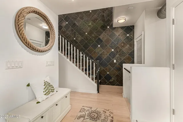a view of a livingroom with wooden floor and entryway