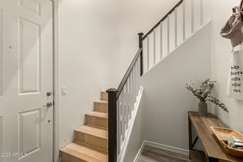 a view of entryway and hall with wooden floor