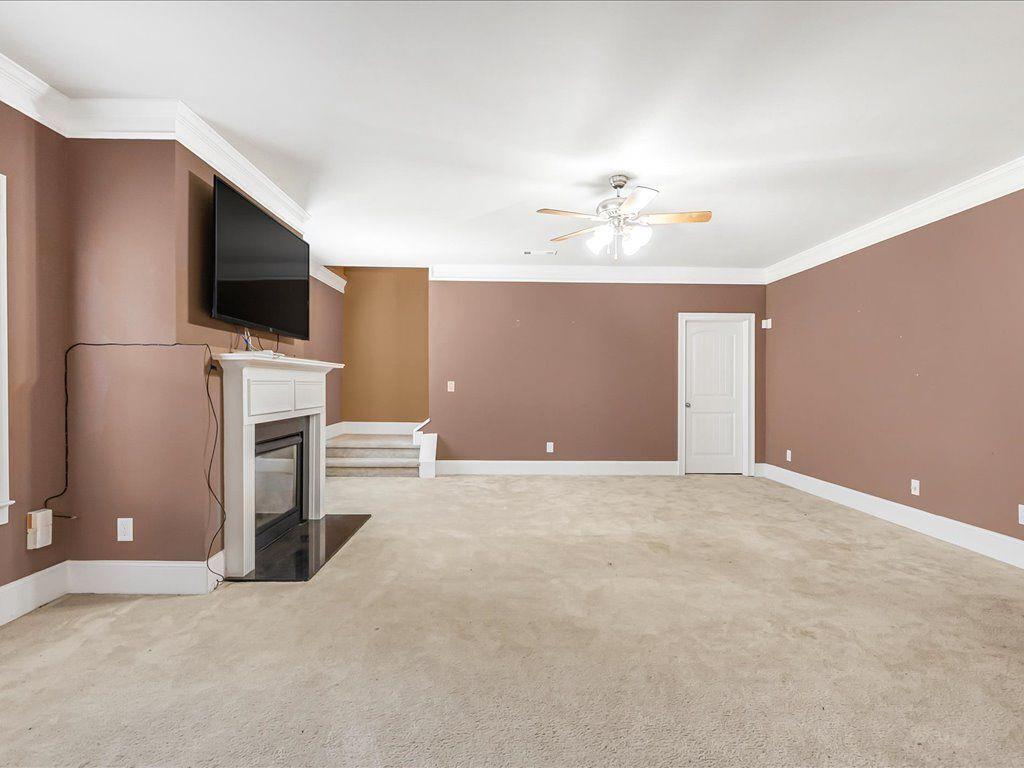80 Lanier Ridge Acworth, GA 30101 - Photo 19 of 59 a view of a livingroom with a flat screen tv and fireplace