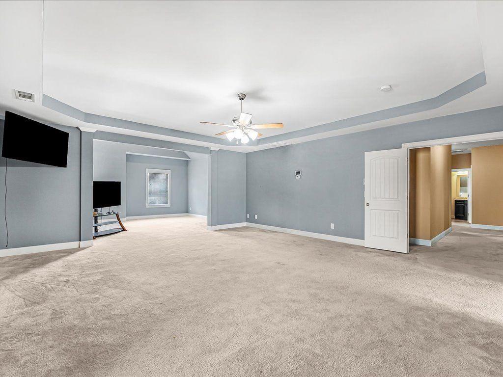 80 Lanier Ridge Acworth, GA 30101 - Photo 29 of 59 a view of a livingroom with an empty space and a ceiling fan