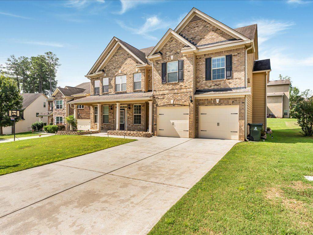 80 Lanier Ridge Acworth, GA 30101 - Photo 3 of 59 a front view of a house with a yard and garage