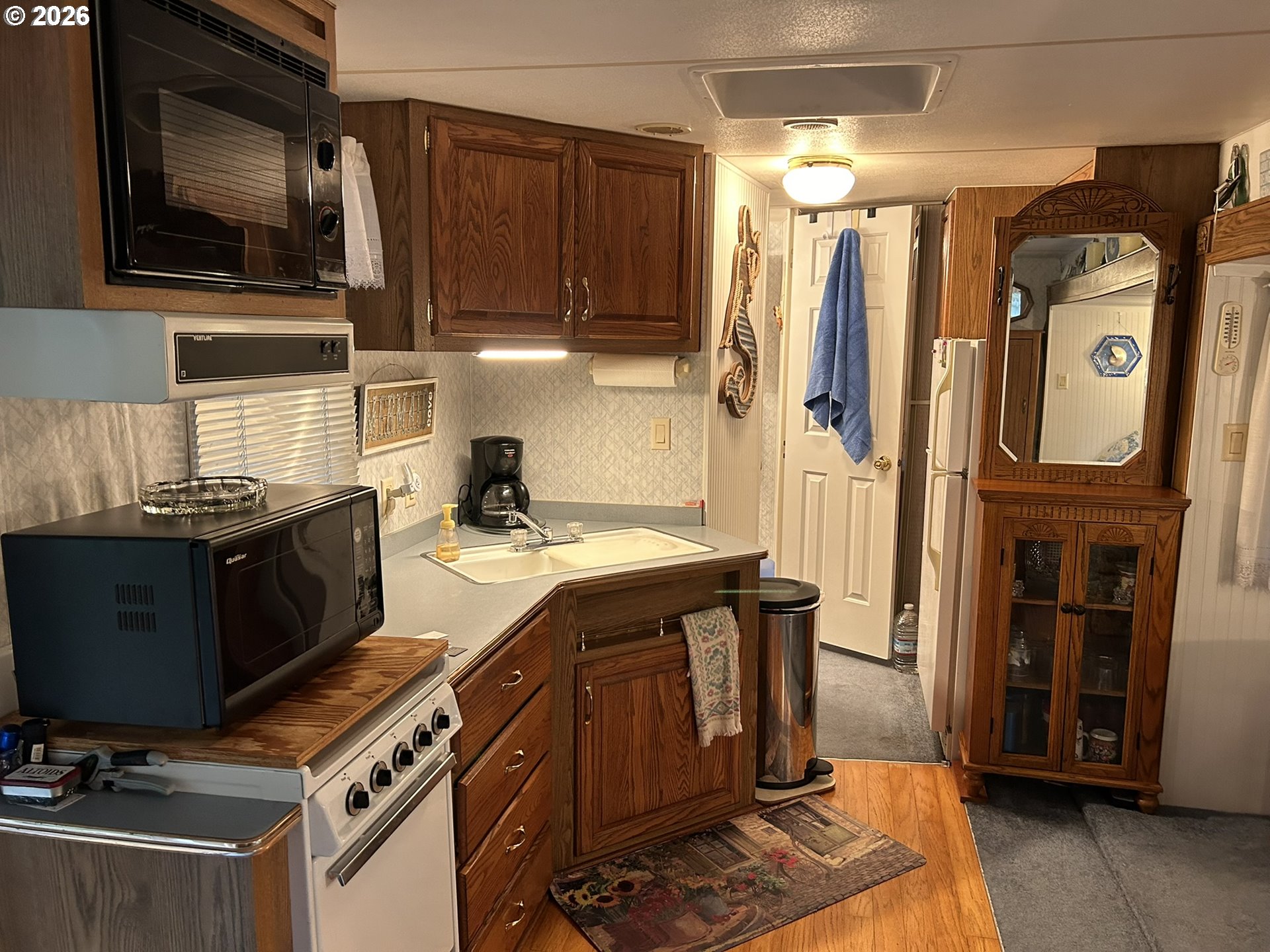 112 Sailor Lane Florence, OR 97439 - Photo 13 of 44 a kitchen with stainless steel appliances granite countertop a stove a sink and a microwave