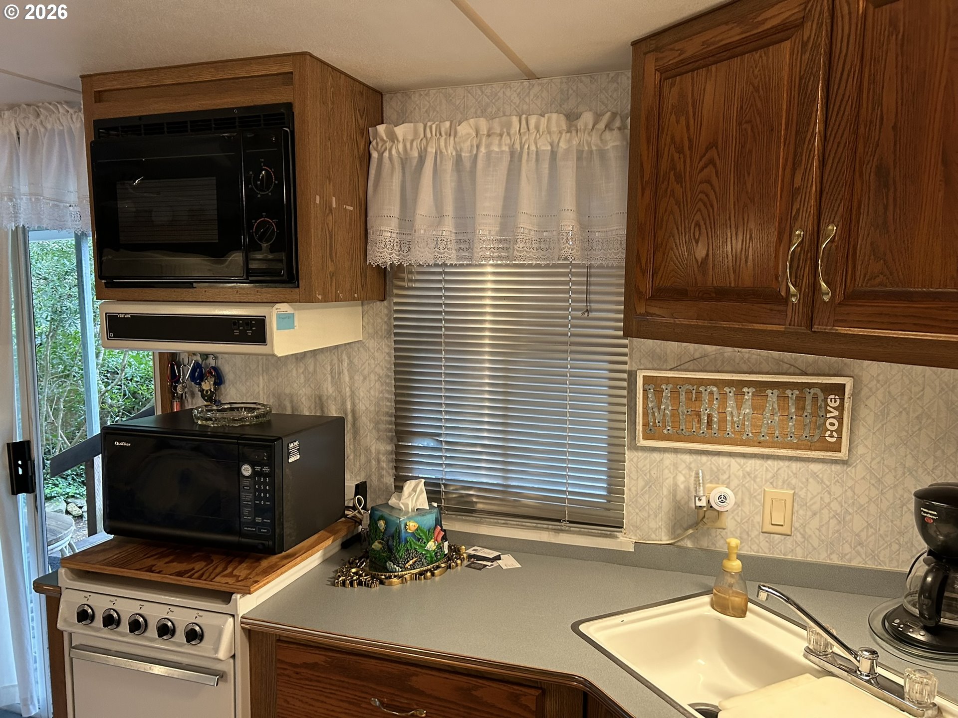 112 Sailor Lane Florence, OR 97439 - Photo 15 of 44 a kitchen with a stove and a sink