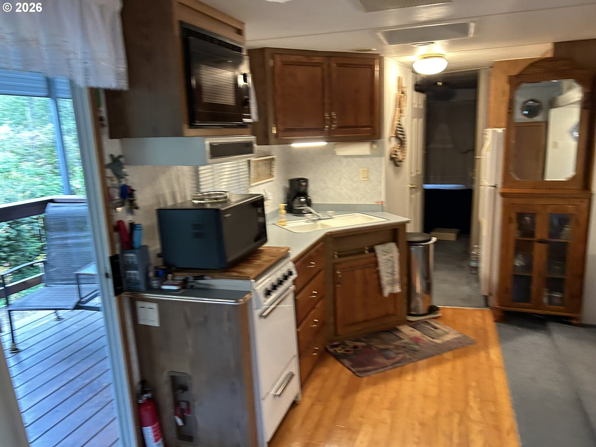 112 Sailor Lane Florence, OR 97439 - Photo 23 of 44 a kitchen with stainless steel appliances granite countertop a stove a sink and a microwave