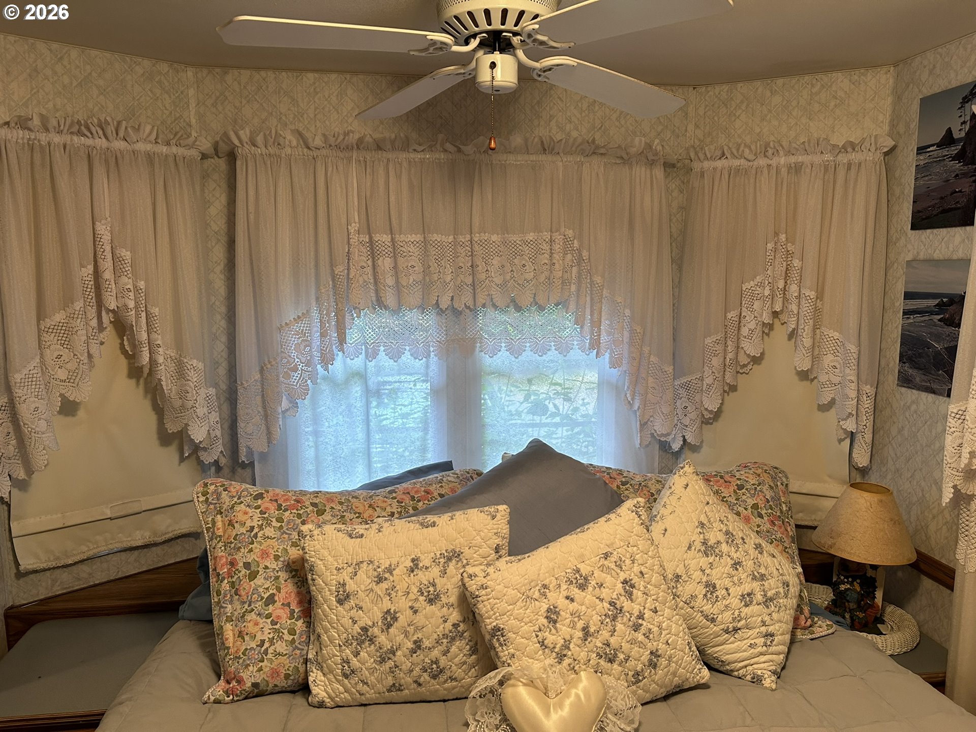 112 Sailor Lane Florence, OR 97439 - Photo 28 of 44 a bedroom with a bed and a chandelier