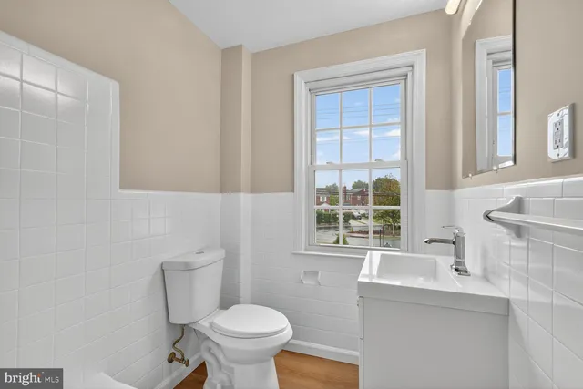 a bathroom with a sink toilet and window