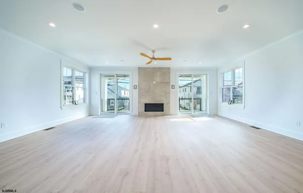 an empty room with wooden floor and fireplace