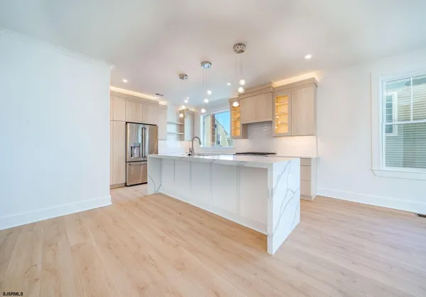 a view of large kitchen with wooden floor and a sink
