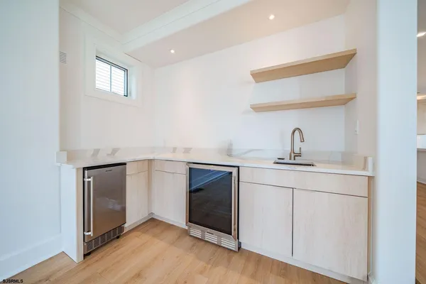 a hallway with sink and mirror