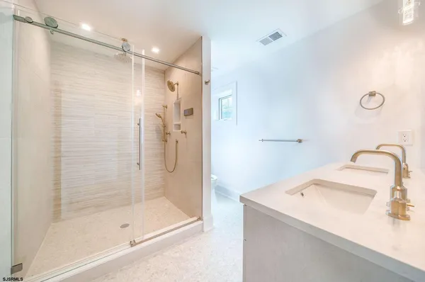 a bathroom with a shower and a sink