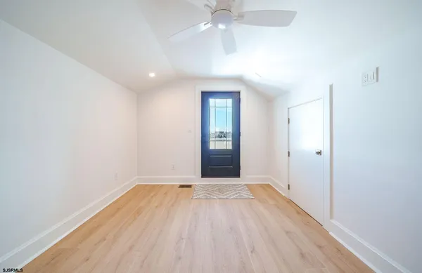 a view of an empty room with wooden floor