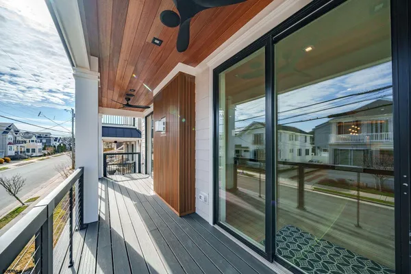 a view of a balcony with furniture and wooden floor