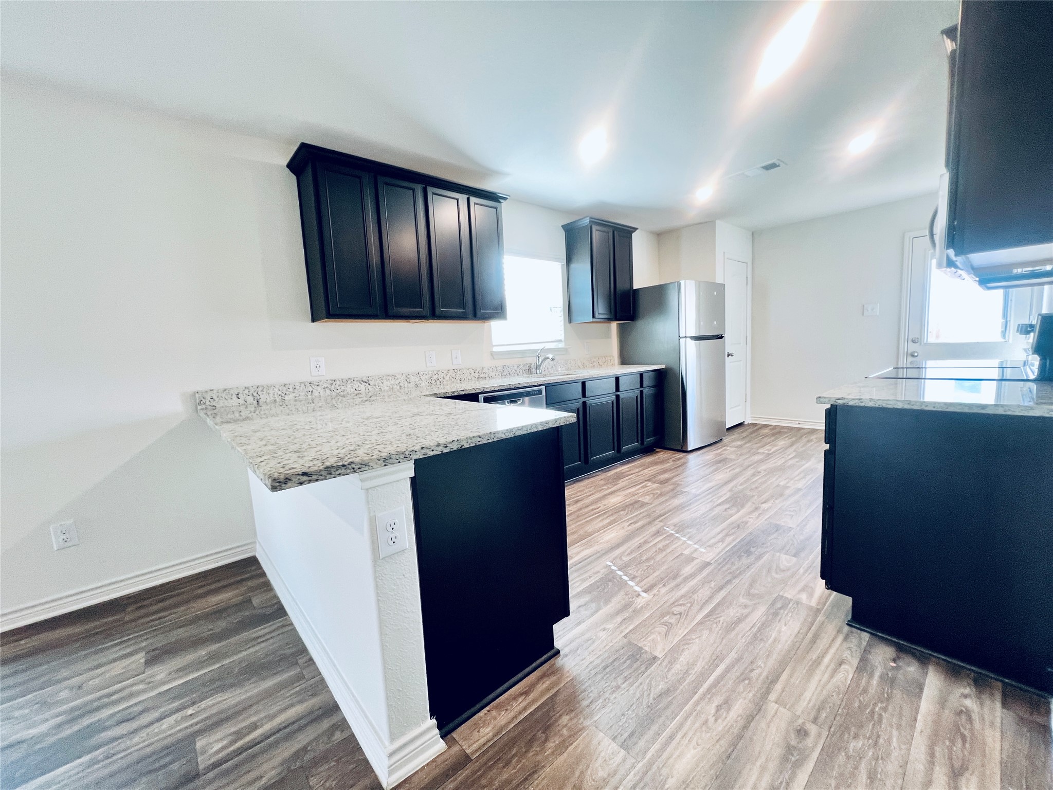 520 Locksley Cove Jarrell, TX 76537 - Photo 5 of 27 A well-appointed kitchen showcasing durable countertops and dark wood cabinetry.
