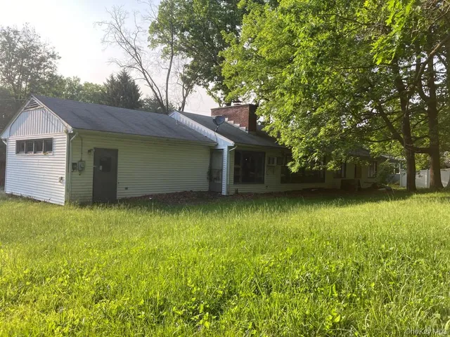 a backyard of a house with lots of green space