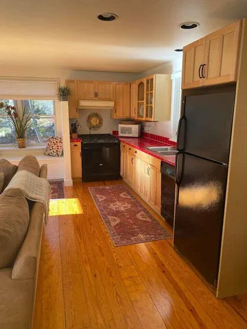 a kitchen with stainless steel appliances granite countertop a refrigerator a sink and a stove