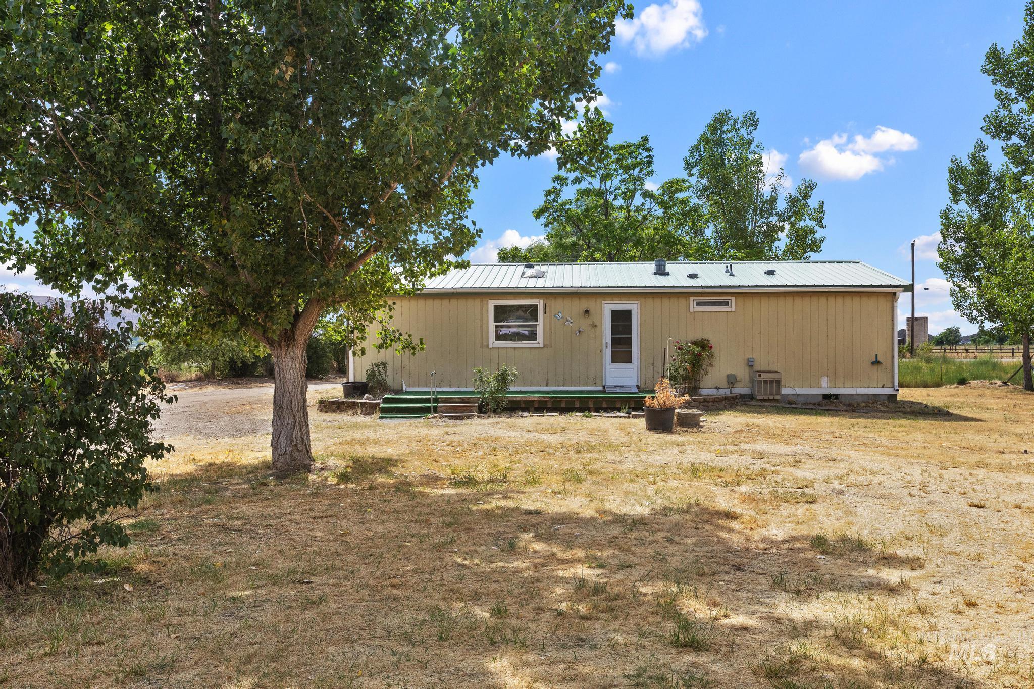 3680 South Mill Road Emmett, ID 83617 - Photo 8 of 38 Single-story home featuring light-colored vertical siding and a light-colored metal roof