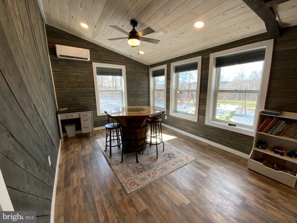 a view of a dining room with furniture window and wooden floor