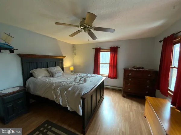 a bedroom with a bed and a dresser