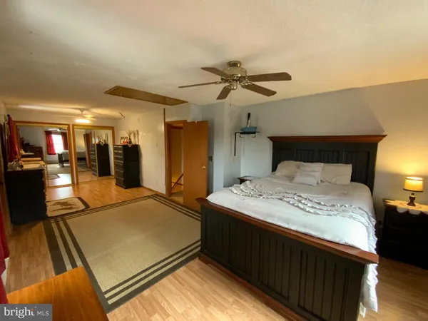 a spacious bedroom with a bed and a chandelier