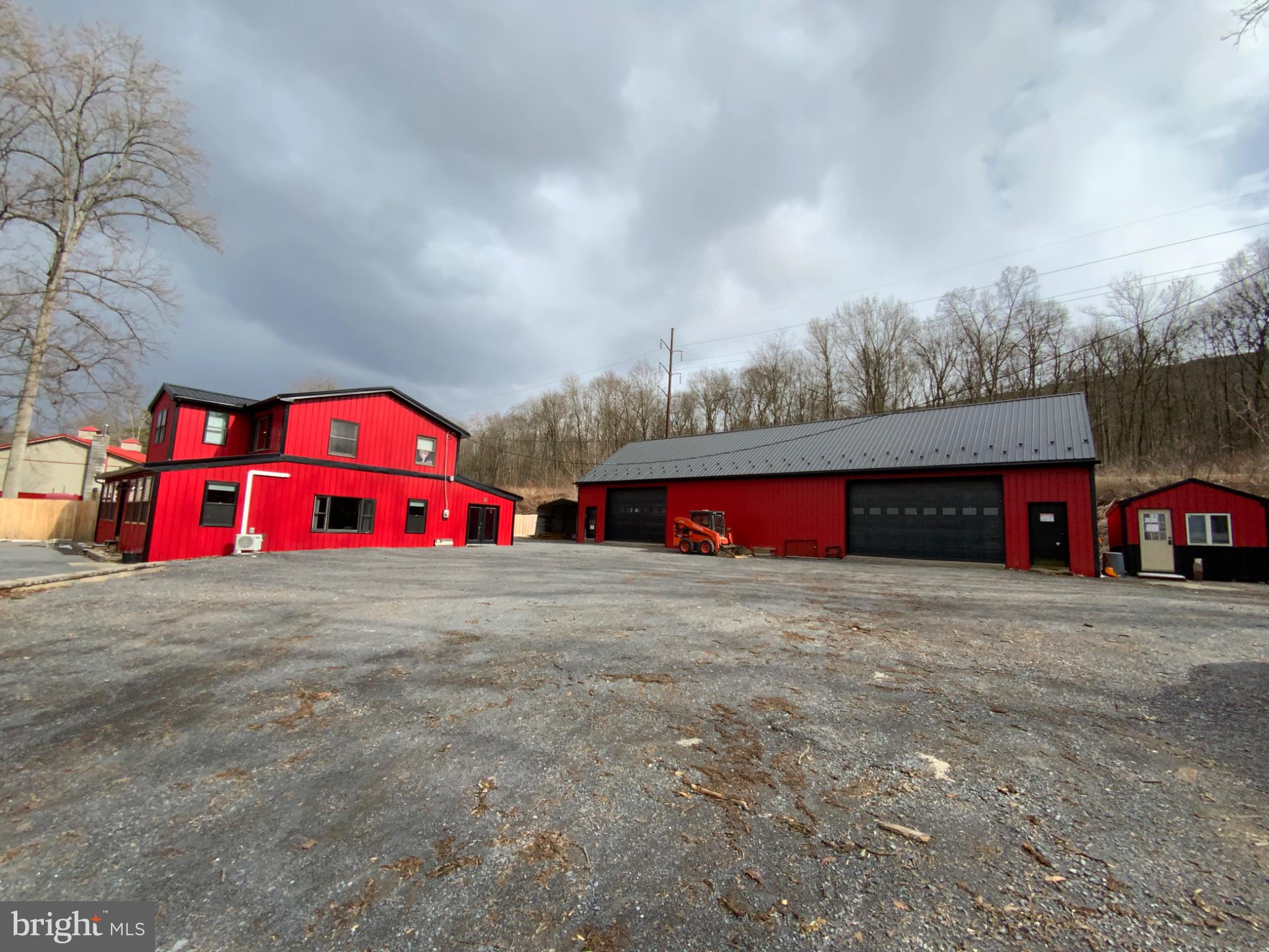 1682 Youngdale Road Lock Haven, PA 17745 - Photo 33 of 36 Vibrant red buildings under moody skies.