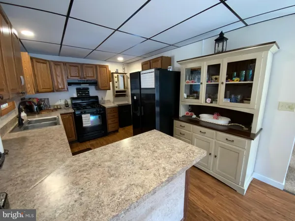 a kitchen with stainless steel appliances granite countertop a stove sink and cabinets