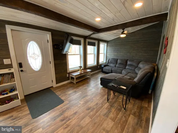 a living room with furniture and a mirror