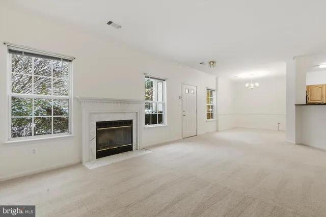 a view of empty room with a fireplace
