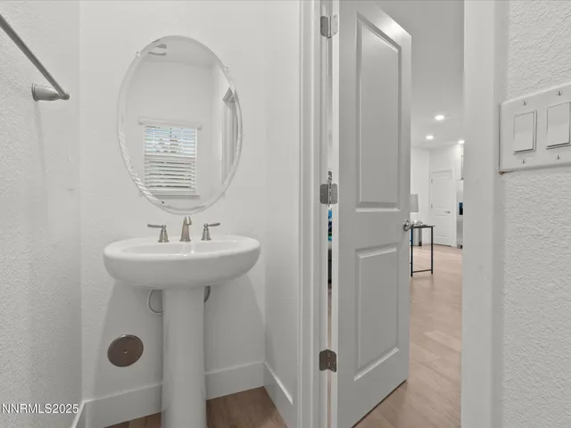 a bathroom with a sink a mirror and shower