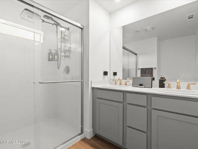 a bathroom with a shower sink and mirror