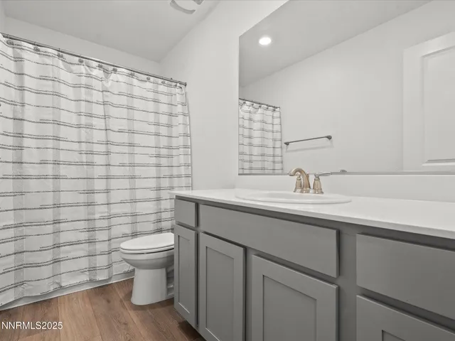 a bathroom with a sink a toilet and mirror