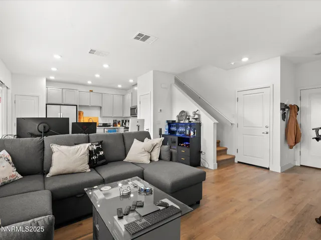 a living room with furniture kitchen view and a couch